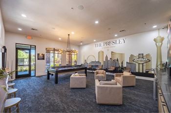 A large room with a pool table and a mural of the Las Vegas skyline.